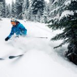 girl with special ski equipment is riding and jumping very fast in the mountain forest