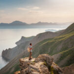 Young man travels alone on the backdrop of the mountains